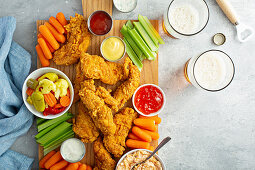 Southern fried chicken platter with all the sauces celery and carrots