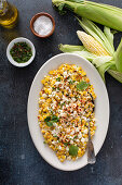 Mexican street corn, elote with cotija cheese, fresh cilantro and chili