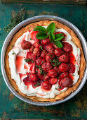 Pie with baked strawberries in a baking pan