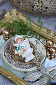 Angel figurine in soup spoon on vintage-style mirrored tray
