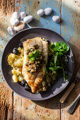 Cod fillet with potatoes, olives and capers