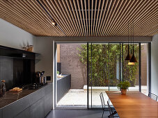 Modern kitchen counter continuing onto courtyard terrace