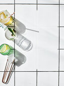 Various cocktails with ice cubes on a tiled floor