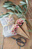 Carnations in waffle cones and olive twigs