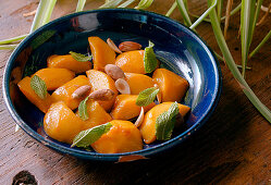 Roasted Peaches with almonds and mint prepare