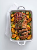 Stuffed roast veal with peas and potatoes