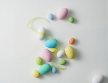 Easter eggs and ribbon on a white surface