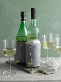 Wine bottles in felt cooling sleeves