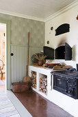 Old wood-fired stove and oven in country-house kitchen