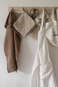 Kitchen textiles hung from peg rack