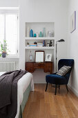 Old dressing table in niche below integrated shelves