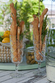 Champagne flutes with bread sticks and rosemary