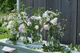 Flower decoration with roses, bluebells, vetch, chamomile, mustard, cumin, vetch and yarrow, gooseberries as decoration