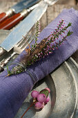 Budding heather with a feather as napkin decoration