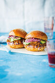 Burgers with pulled pork, pickles and coleslaw