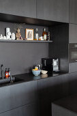 Fitted kitchen with dark cabinets