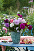 A dahlias bouquet and autumn asters, apples and ornamental apples as decoration