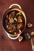 Stew pot with lamb, beef brisket and fresh figs