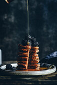 Pumpkin pancakes with blackberries and maple syrup
