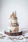 A two-tier baked apple cake with cinnamon buttercream and Christmas decorations