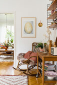 Rocking chair and serving trolley next to open doorway in bright room