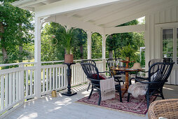 An antique table with chairs on a covered terrace