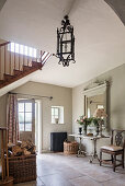 Log basket in spacious entrance hallway of restored farmhouse