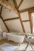 Freestanding bath below timber framed attic in restored 16th century farmhouse