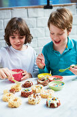 Boys preparing rice pop doughnuts