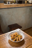 Plate with traditional Asian gyozas filled with vegetables and served with Sriracha hot sauce with mustard and soy