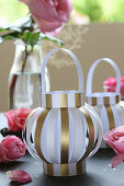 Lanterns handmade from gold and white striped paper