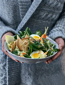 A winter bowl with cream cheese, bread chips and boiled eggs