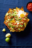 Chilaquiles with black beans, corn, tortilla chips and fried eggs