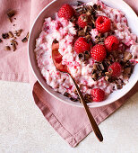 Pink rice pudding with raspberries and dark chocolate