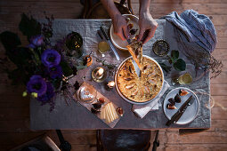 Sauerkraut quiche with apples on a festively laid table for two