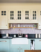 Belfast sink in pale-blue base unit below cream wall cabinets