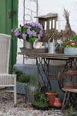 Vase of lilac on old sewing machine base decoratively arranged on terrace