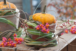 Patisson pumpkin as a table decoration with grass cuff and common spindle