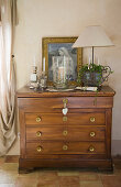 Antique wooden chest of drawers with nostalgic decoration and picture of the Virgin Mary