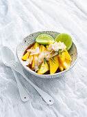 Fruit salad with mango, kaffir lime and coconut chips