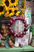 Wreath of red bulbs and bouquet of sunflowers