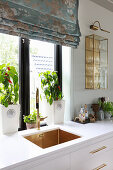 White kitchen counter with undermount sink below window