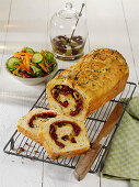 Red pesto roll with salami and black olives