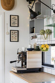 Coffee machine in kitchen with grey shelf modules on wall