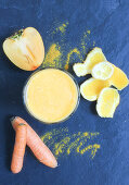 A yellow smoothie made from carrots, oranges and persimmons