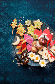 Various colourful Christmas biscuits on plate