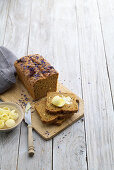 Wholemeal spelt bread, sliced, with curls of butter