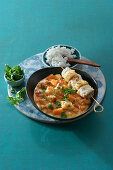 Pumpkin-coconut curry with fish skewer and rice
