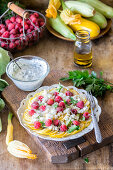 Zucchini carpaccio with raspberries and cottage cheese