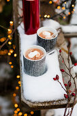 Hot chocolate with marshmallows in the snow